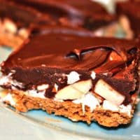 Rocky Road Bars made with a graham cracker crust, and then layered with fudgy chocolate, marshmallow creme and almonds! These treats seem to vanish before your eyes!