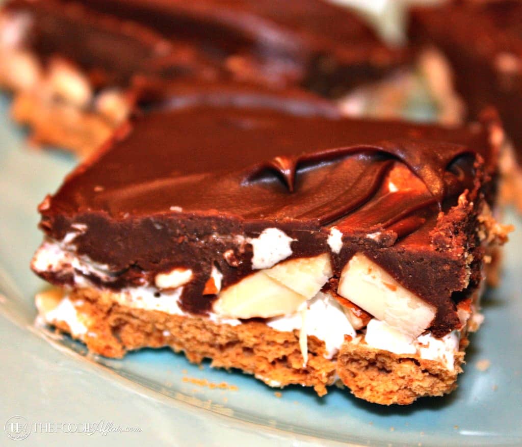 Rocky Road Bars made with a graham cracker crust, and then layered with fudgy chocolate, marshmallow creme and almonds! These treats seem to vanish before your eyes!