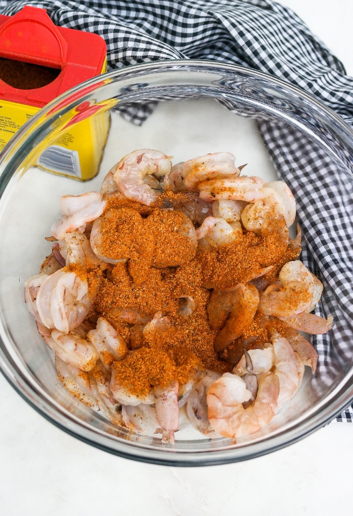 Shrimp in a clear bowl with spices.