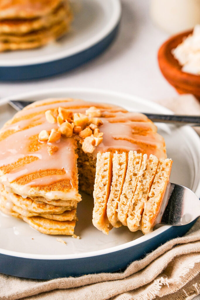 Stack of pancakes on a white a blue plate. 