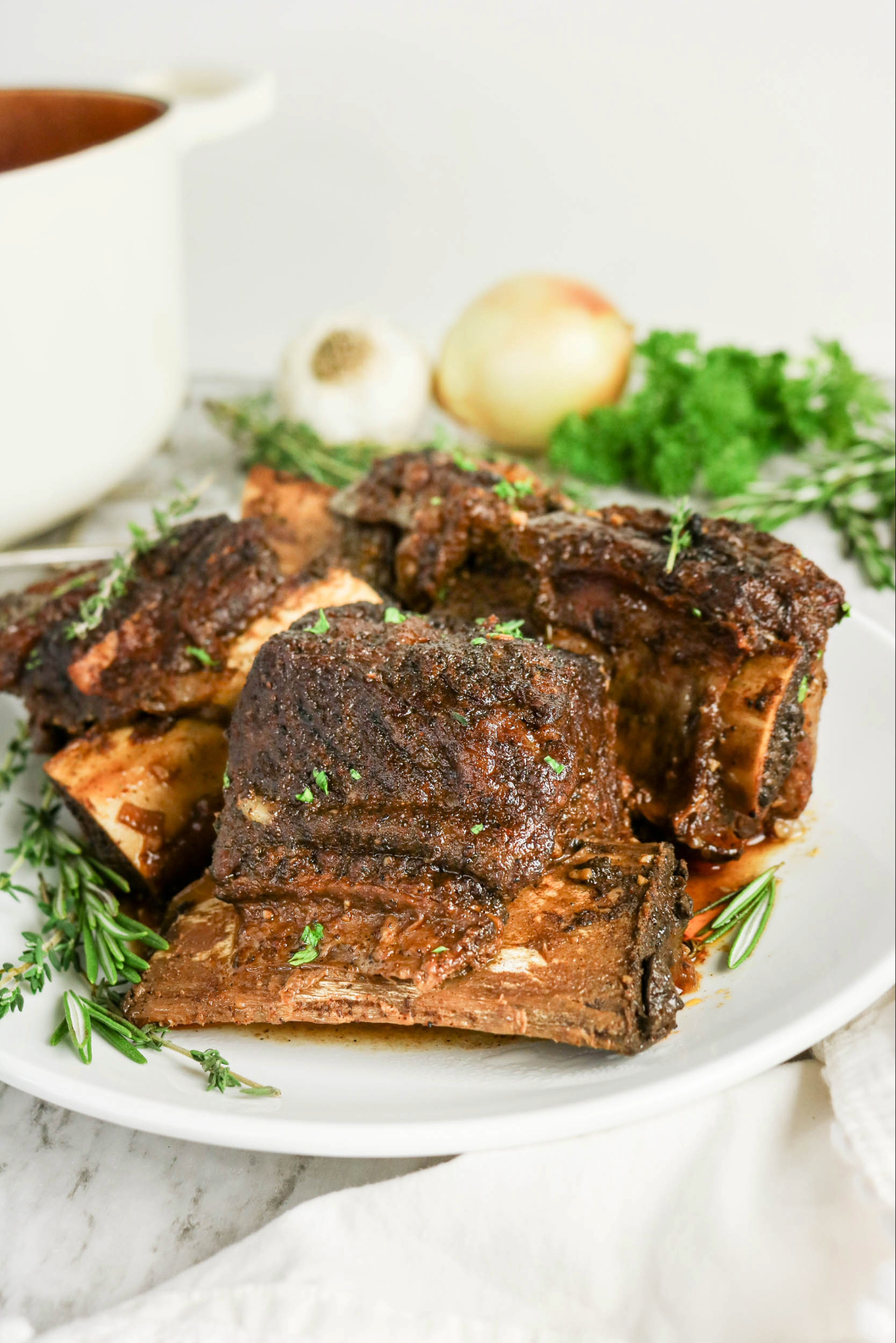 short ribs on a white dinner plate.