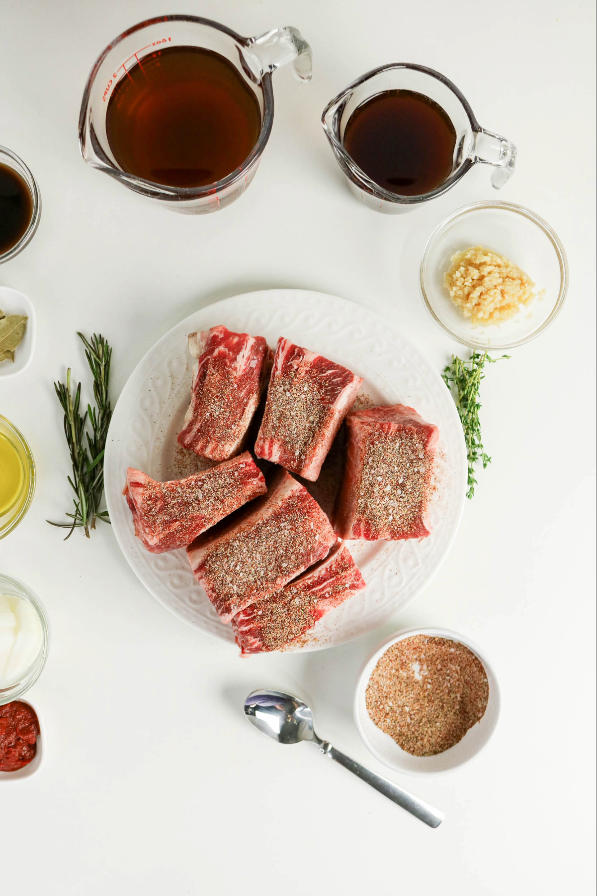 Seasoning short beef ribs before braising.
