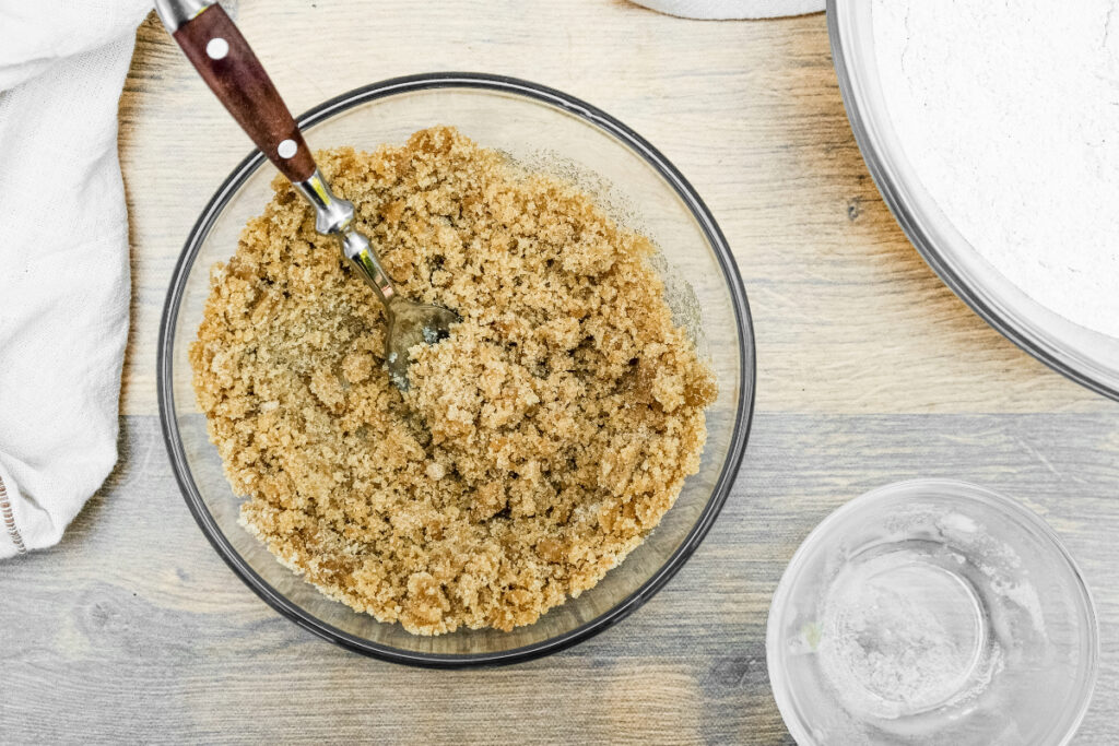 Brown sugar mixed with butter in a small mixing bowl. 