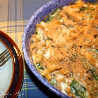 chicken casserole dish with spinach in a blue serving dish