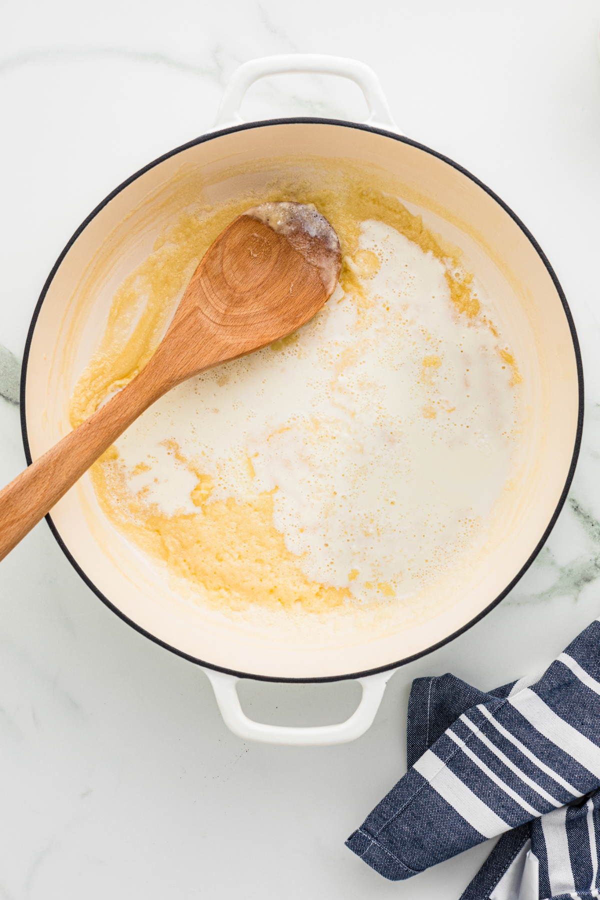 Milk and cream in a large saucepan with butter and flour mix. 