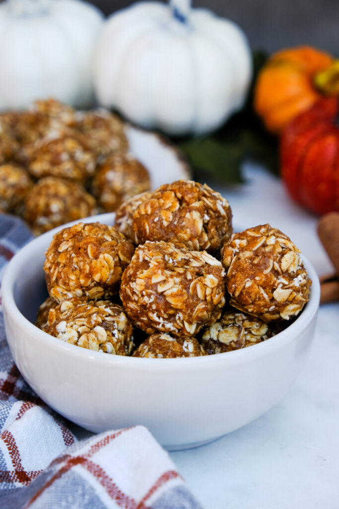 Pumpkin protein balls in a small white bowl. 