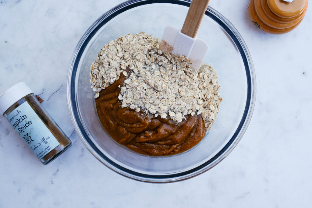 Oatmeal mix with peanut butter mix in a mixing bowl.