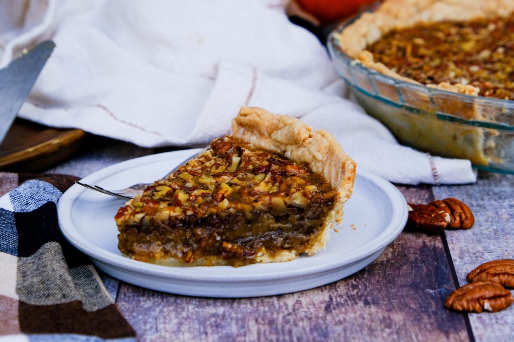 Old fashioned pecan pie on a serving plate.