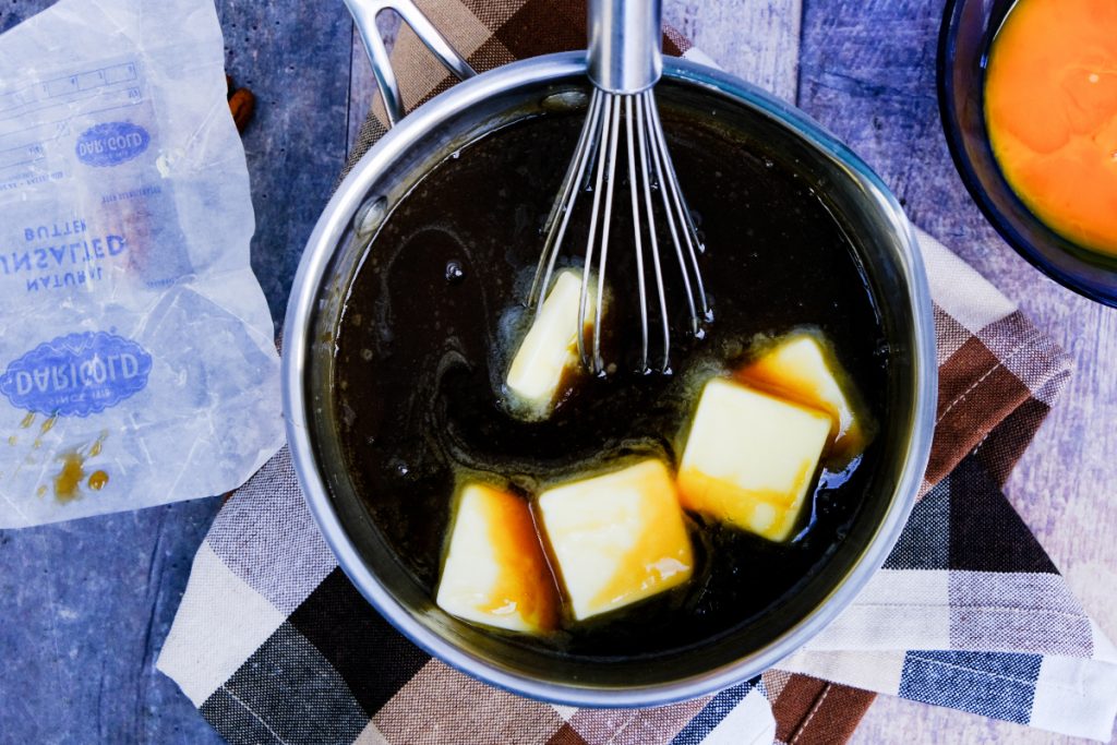 Sliced butter in a saucepan with maple syrup filling mix. 