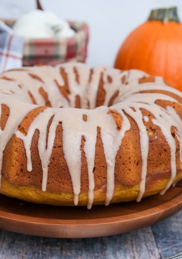 Pumpkin bundt pound cake on a wooden serving platter. 