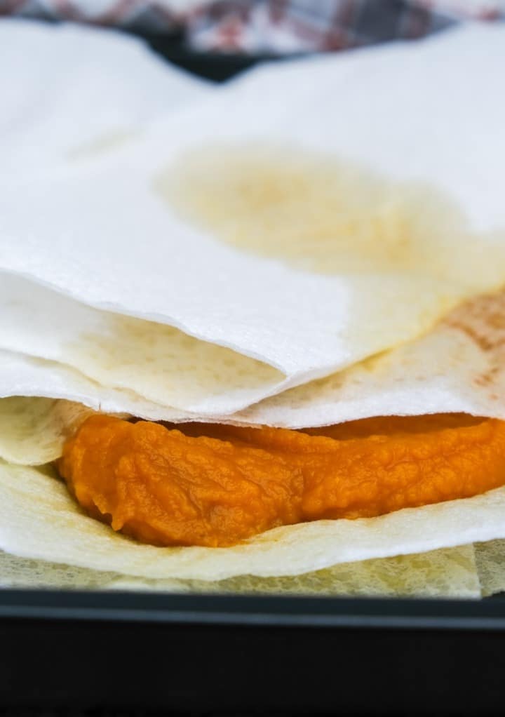 Pumpkin puree between paper towels to remove some moisture. 