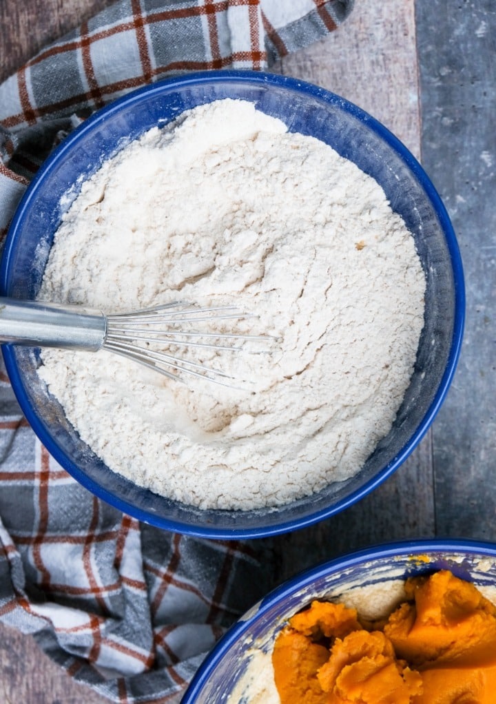 Dry ingredients for pound cake in a blue mixing bowl. 