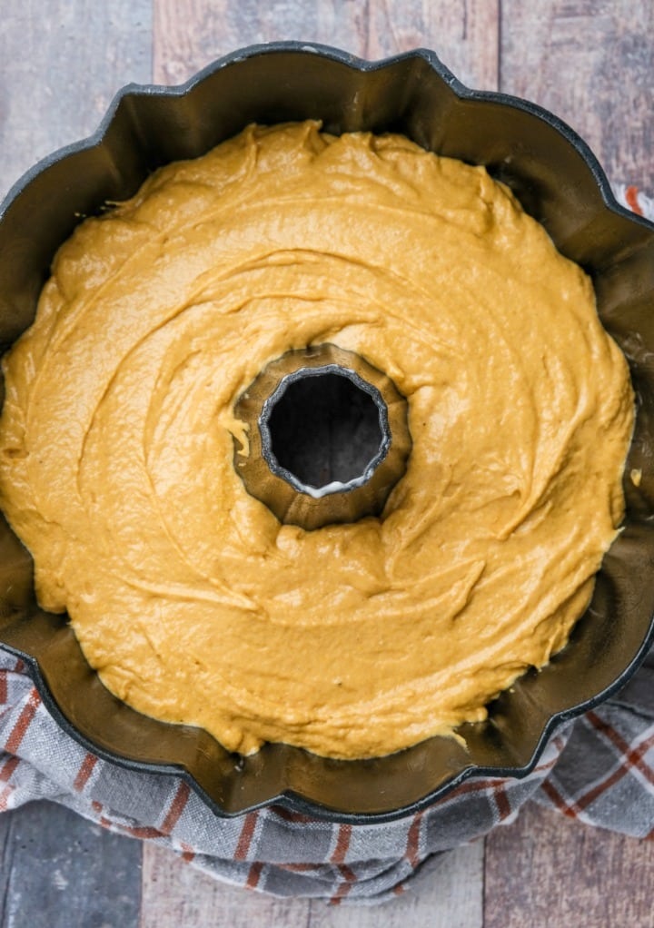 Pumpkin pound cake batter in a bundt cake pan ready to bake in the oven. 