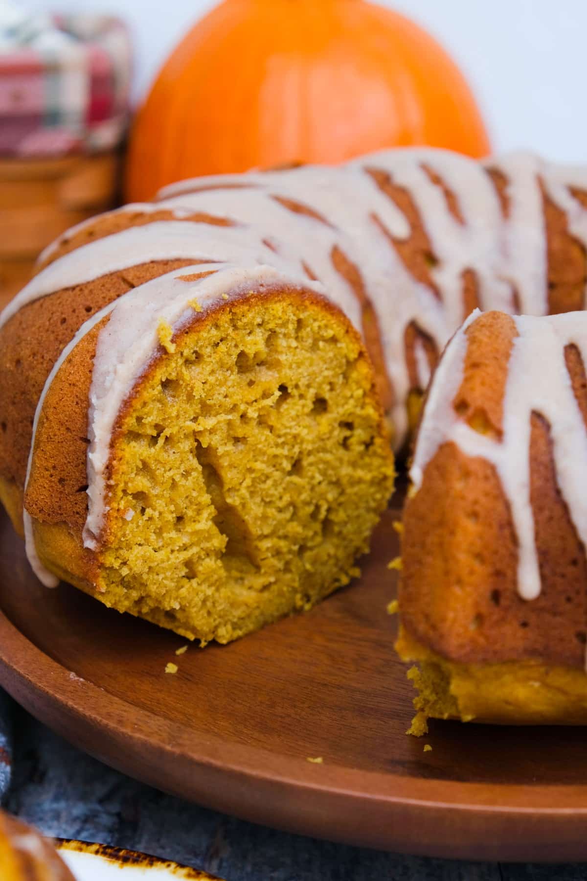 Sliced Pumpkin spice bundt cake on a wooden serving dish.
