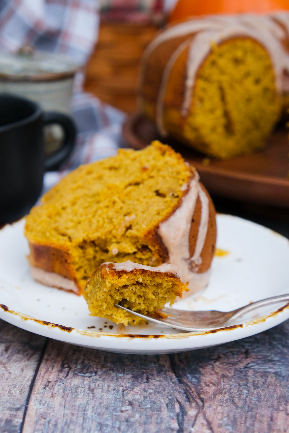 A slice of pumpkin cake with a forkful ready to eat.