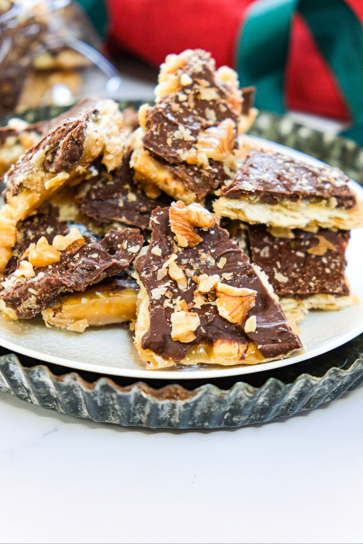 Saltine cracker bark on a white plate and tin serving platter.