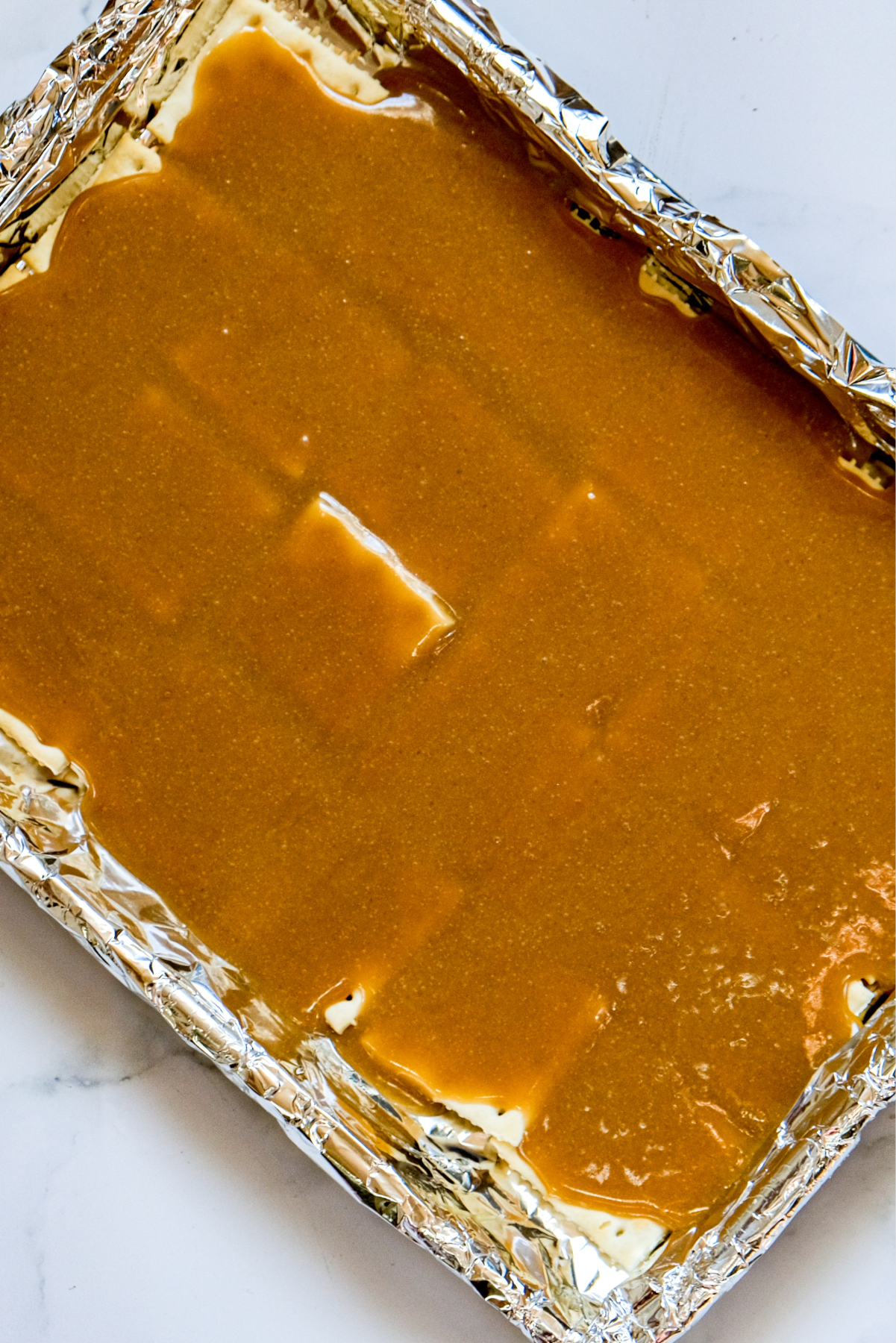 Caramel sauce over saltine crackers.