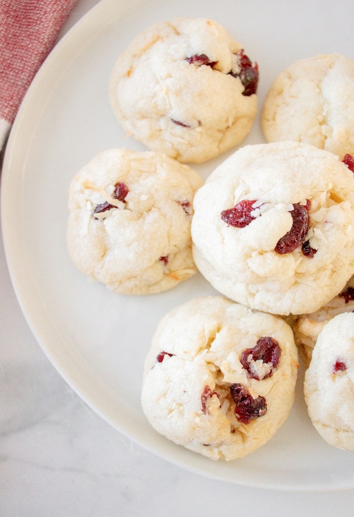 A top view of cranberry cookies on a white plate ready to eat. 