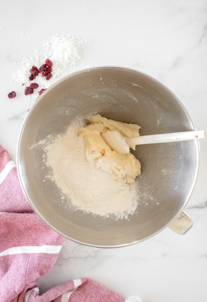 Here we add flour to the butter mixture to make cookies.