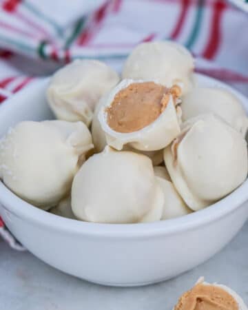 No bake peanut butter snowballs in a white bowl.