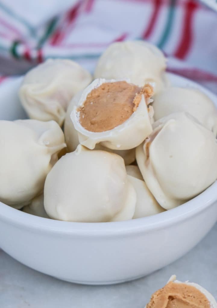 Peanut butter snowballs in a white bowl ready to eat. 