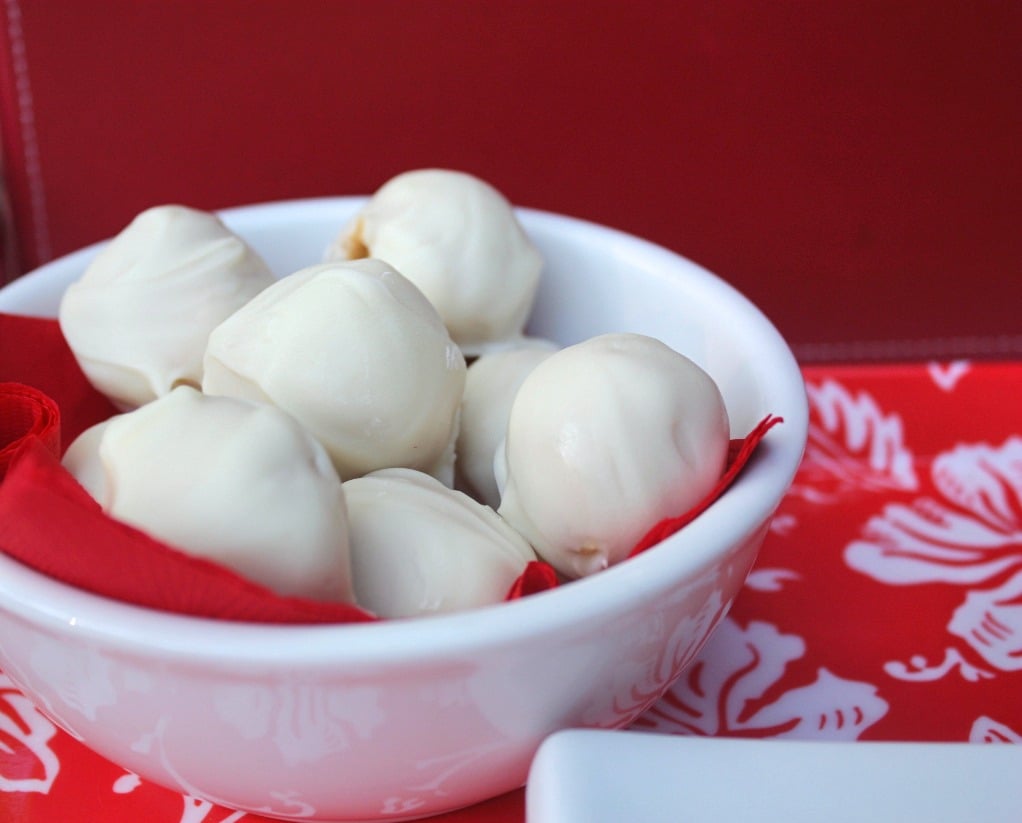 A white bowl filled with peanut butter snowball treats