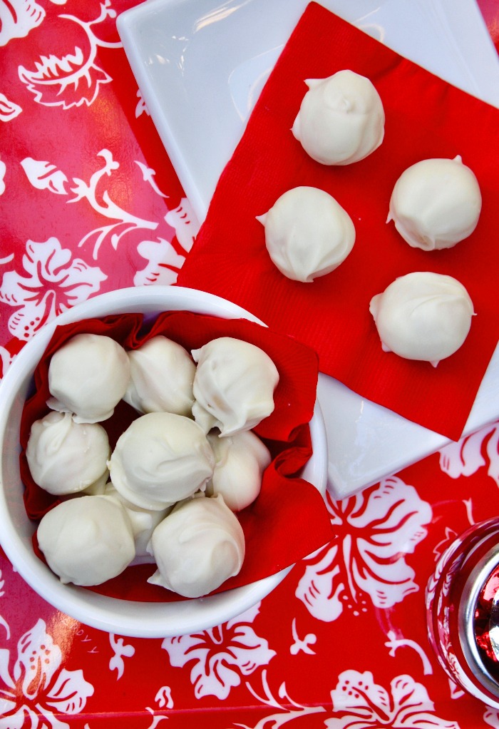 No bake peanut butter snowballs in a white bowl with red napkin