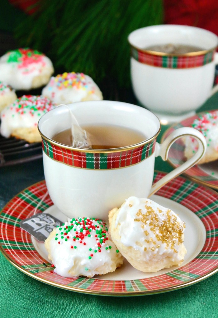 Holiday ricotta cookies on a plaid red and green plate