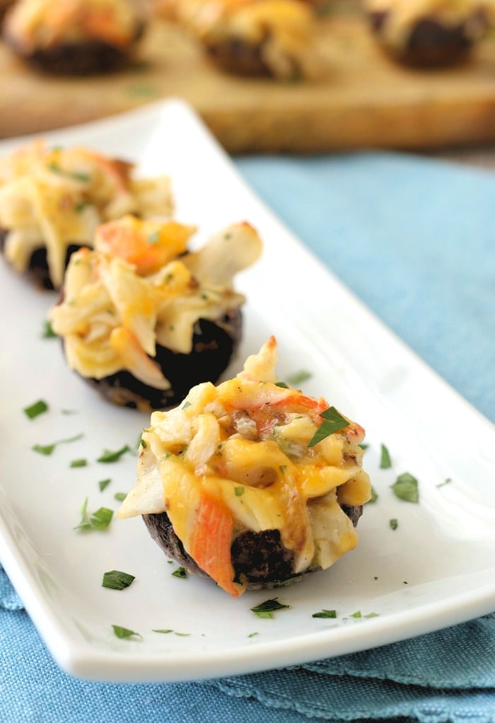 A final image of the finished crab stuffed portabella mushrooms on a platter ready to be served. 