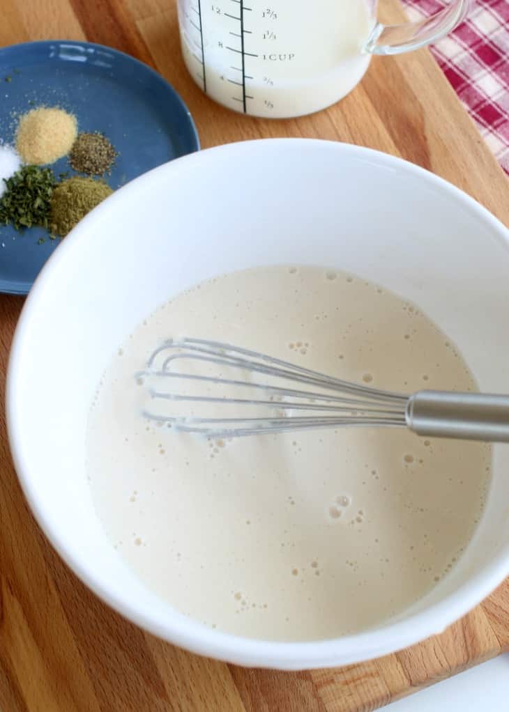 Flour and milk whisked together for a cream of mushroom recipe.