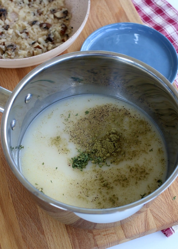 Spices added to the milk in a cream of mushroom recipe.