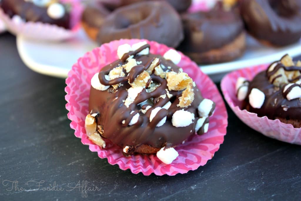 Rocky road chocolate mini donuts on a black tray