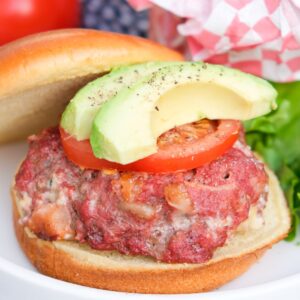 Blue cheese burgers with bacon topped with avocado and tomato.