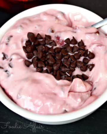 Cherry dip with chocolate chips in a white serving dish.