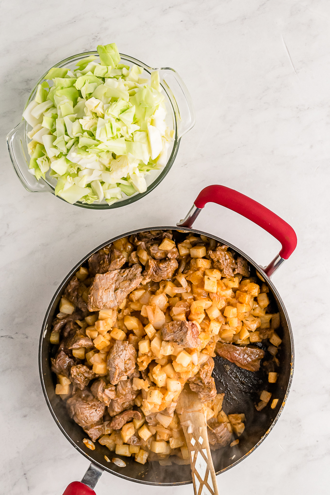 Meat and potato filling for hand pies in a skillet. 