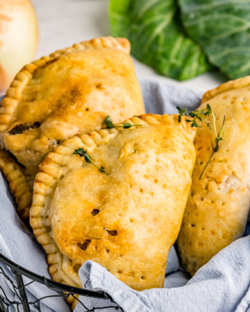 Meat hand pies in a basket ready to eat.