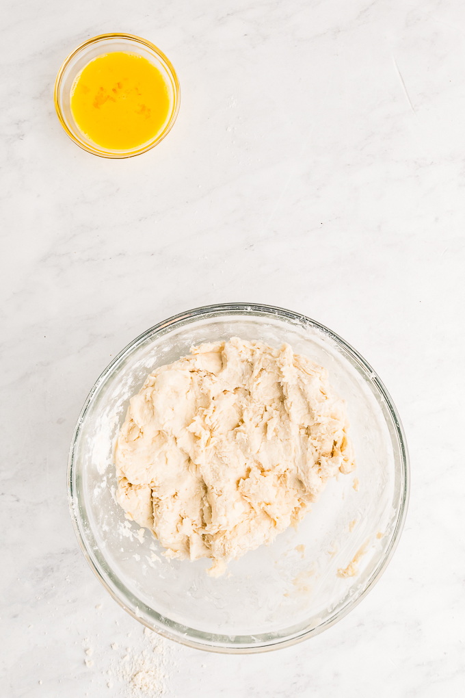 Pie dough mixed in a clear bowl.