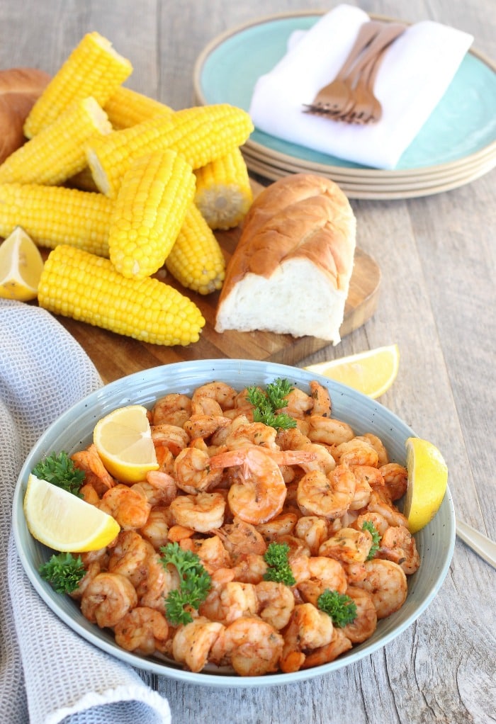 Barbeque shrimp recipe, New Orleans style. Served with sweet corn and bread.