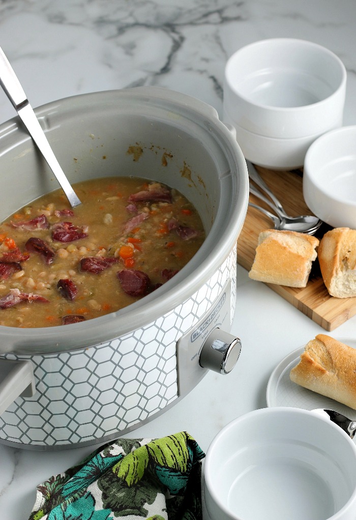 This view shows inside the Crockpot to see the slow cooker ham and beans finished and ready to be served with bread. 