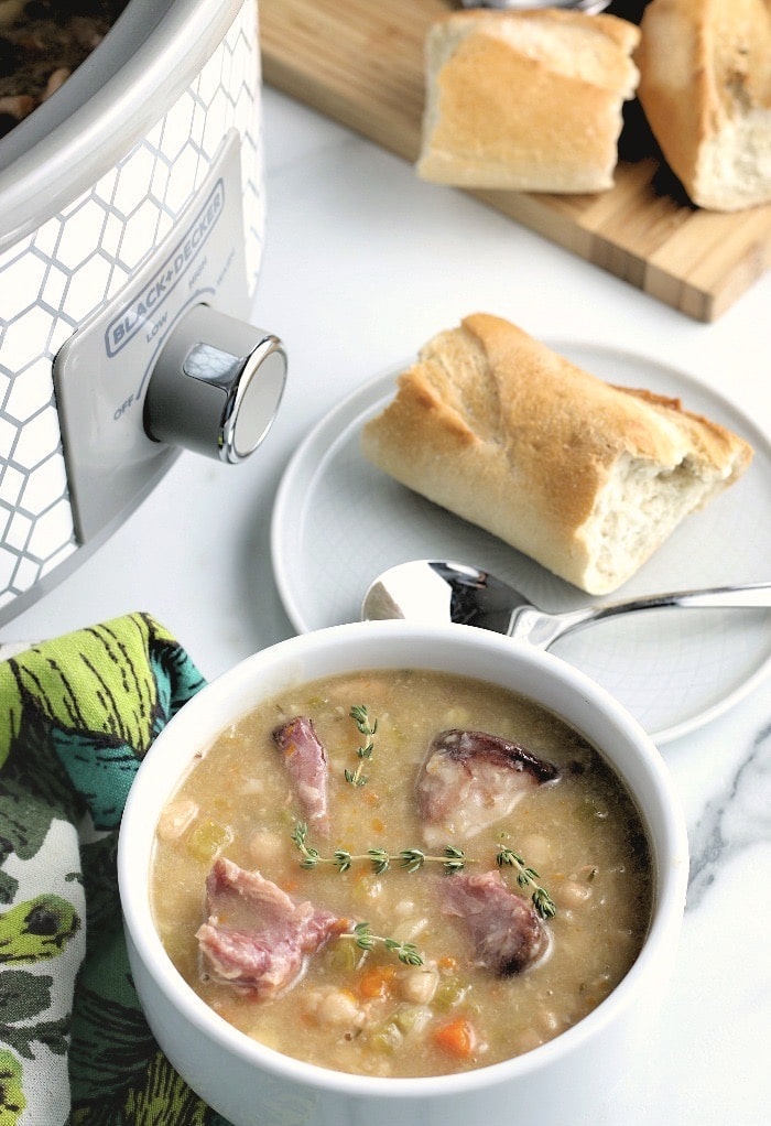 This bowl full of delicious ham and bean soup in a crock pot is ready to be devoured. 