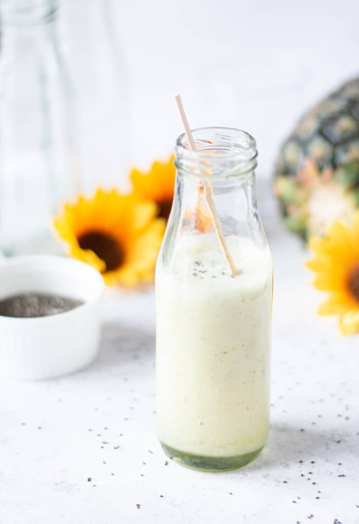 Pineapple smoothie with chia seeds in a clear glass