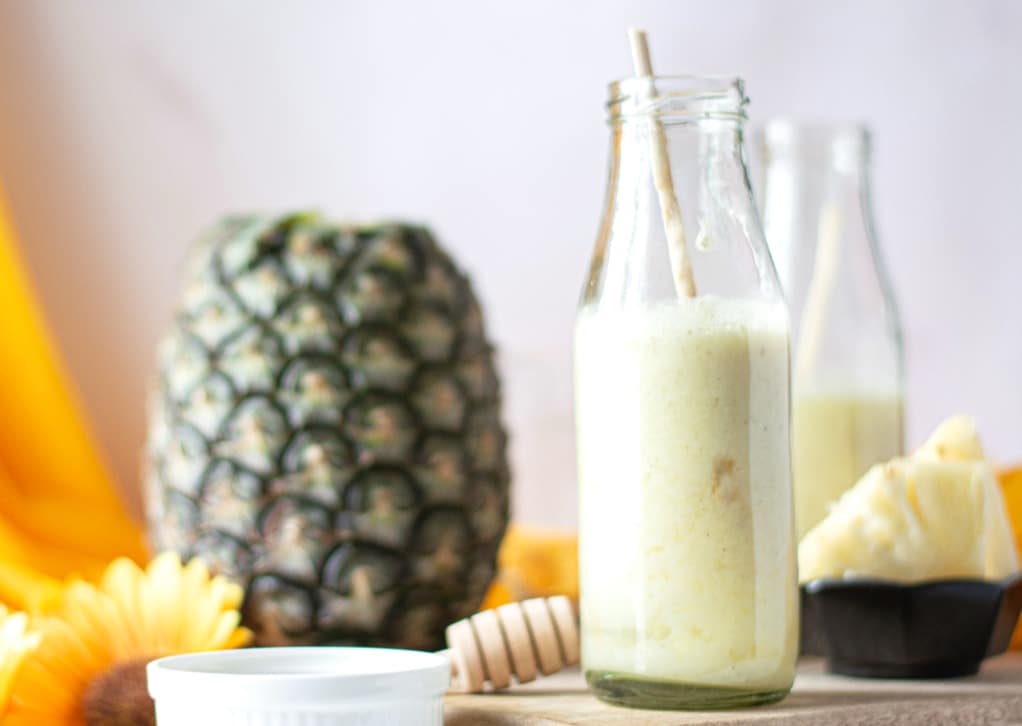 Smoothie in a milk bottle with a pineapple