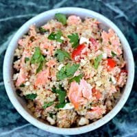 Quinoa Salmon Bowl in a white bowl topped with cilantro