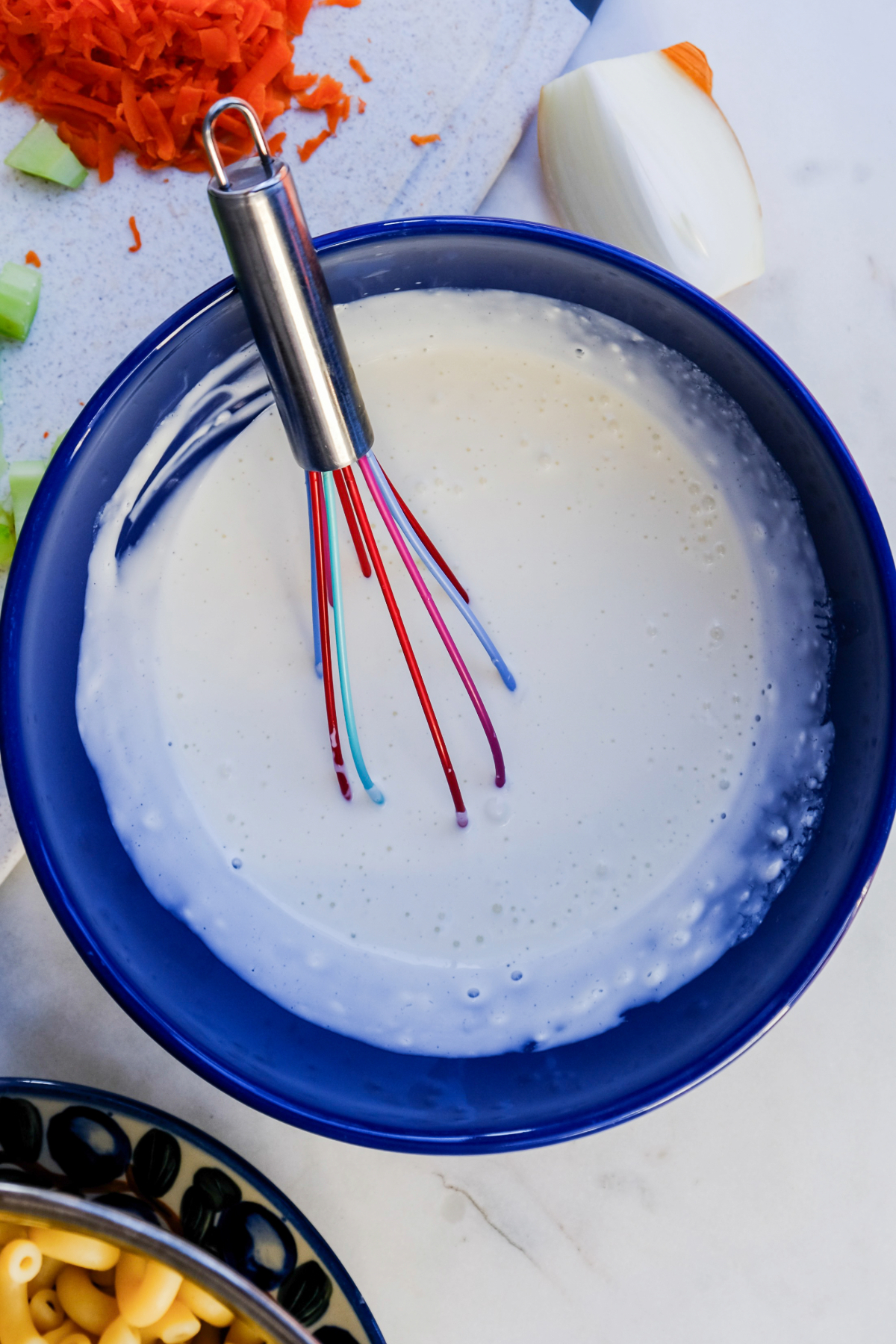 Dressing in a blue bowl for pasta salad.