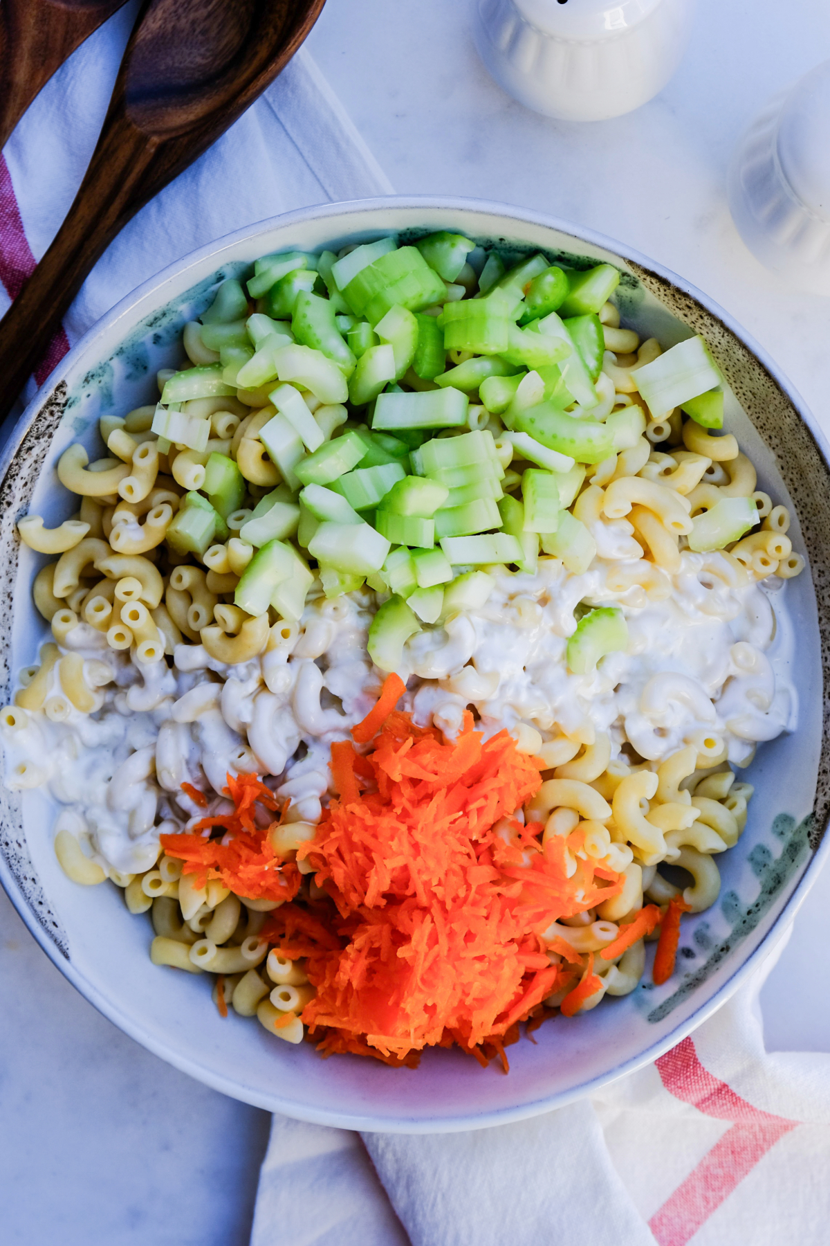Ingredients in a mixing bowl for pasta salad.