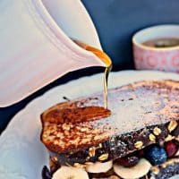 High Protein French Toast Sandwich with maple syrup on a white plate.