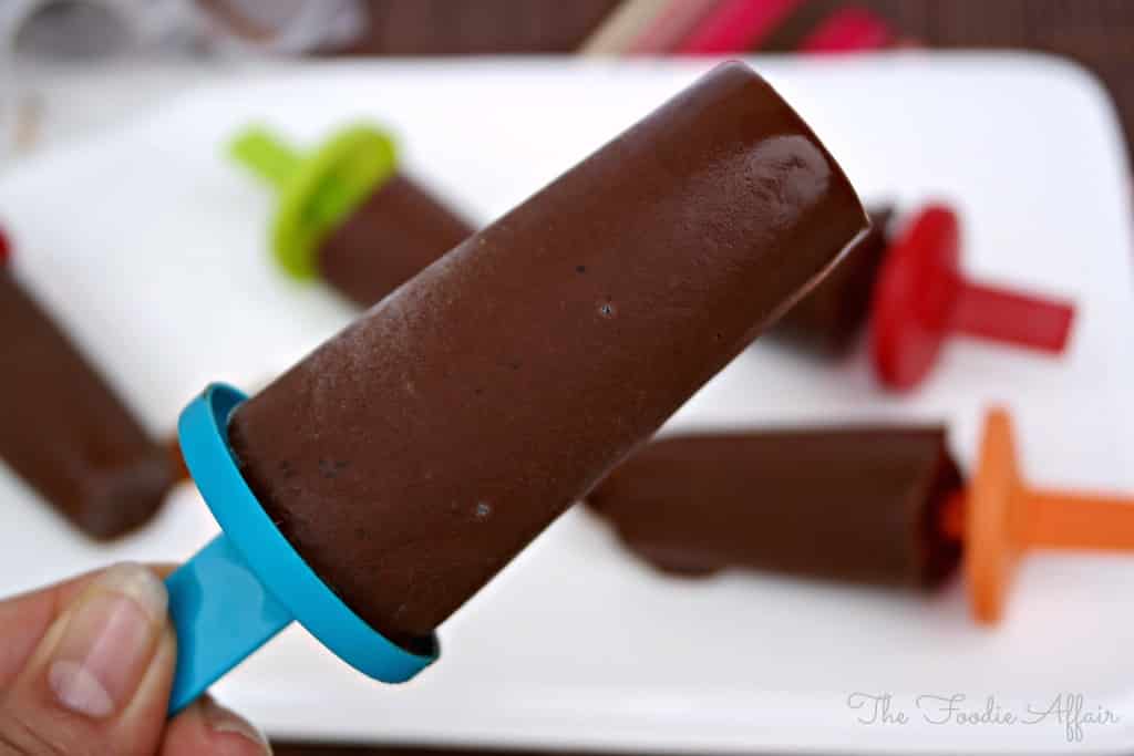 Holding fudge pops over a white plate