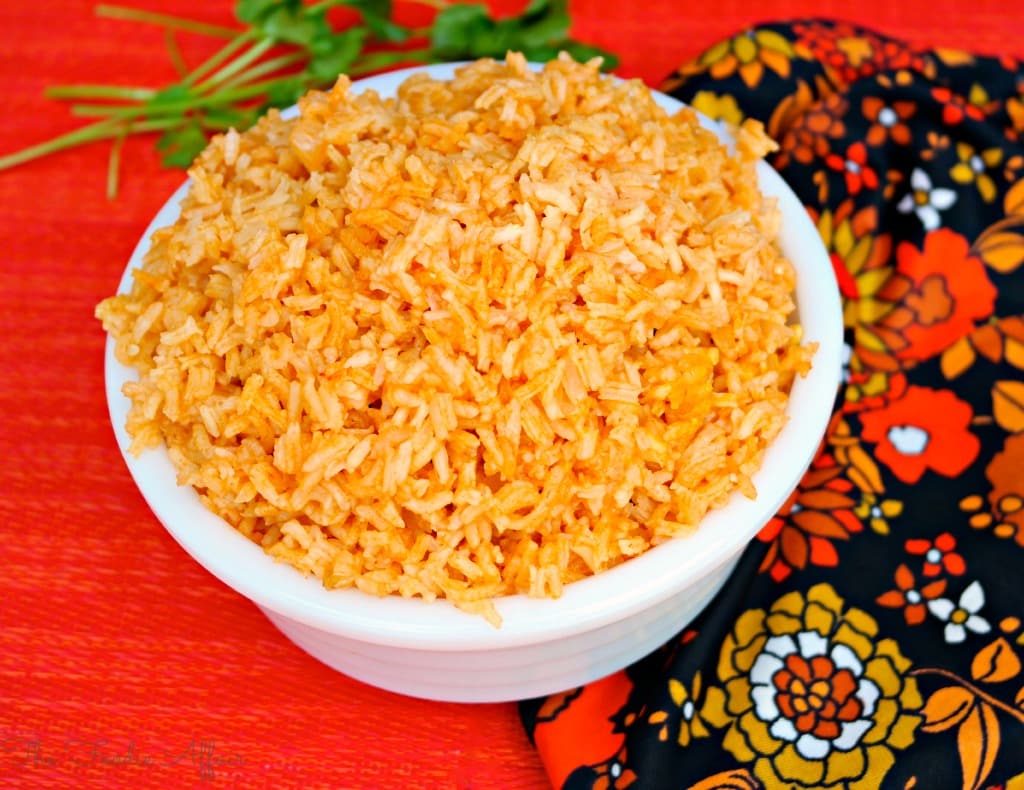 Spanish rice in a white bowl with orange napkin