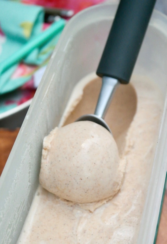 A scoop of homemade ice cream out of a Tupperware container