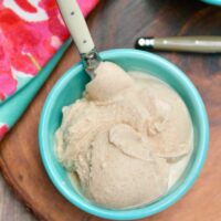 an overhead shot of a bowl of ice cream in a teal bowl